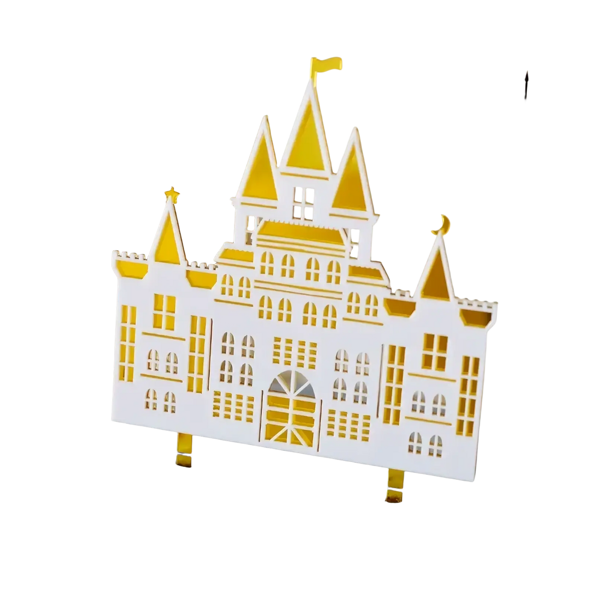 A white and gold acrylic wedding cake topper featuring a castle with intricate cut-out details for bride and groom decor