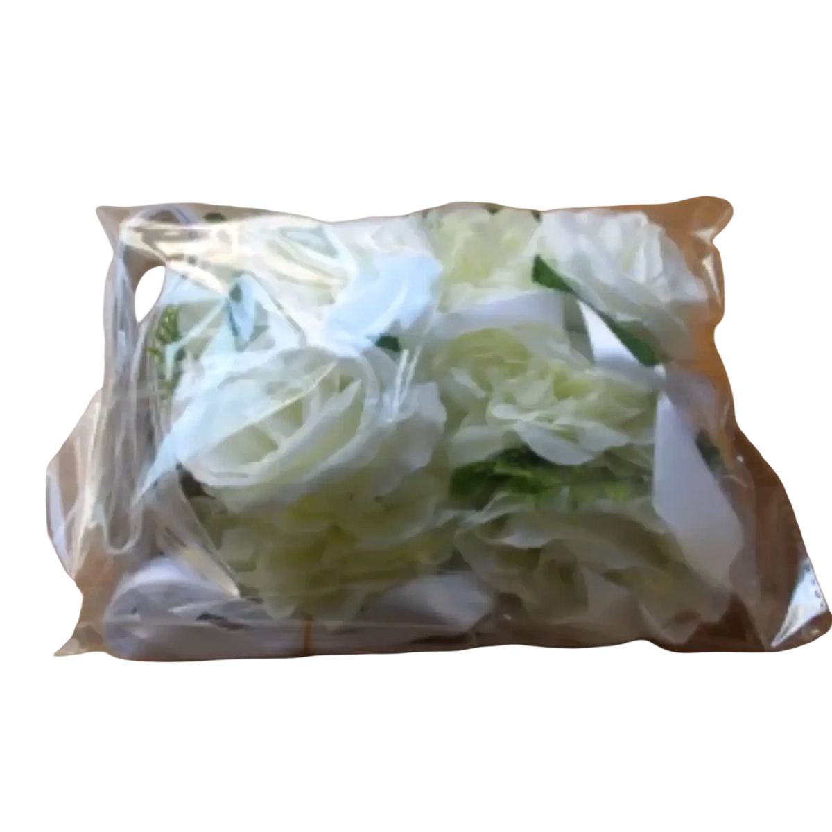A package of artificial white and light green roses wrapped in clear plastic for wedding car decoration