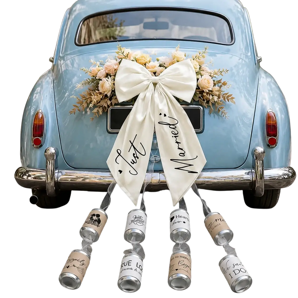 A cream satin wedding car bow with just married script in black and floral accents hanging on a light blue vintage car back