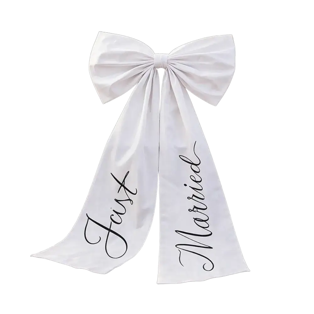 Elegant large white satin wedding car bow with just married in black cursive on tails for wedding day decor