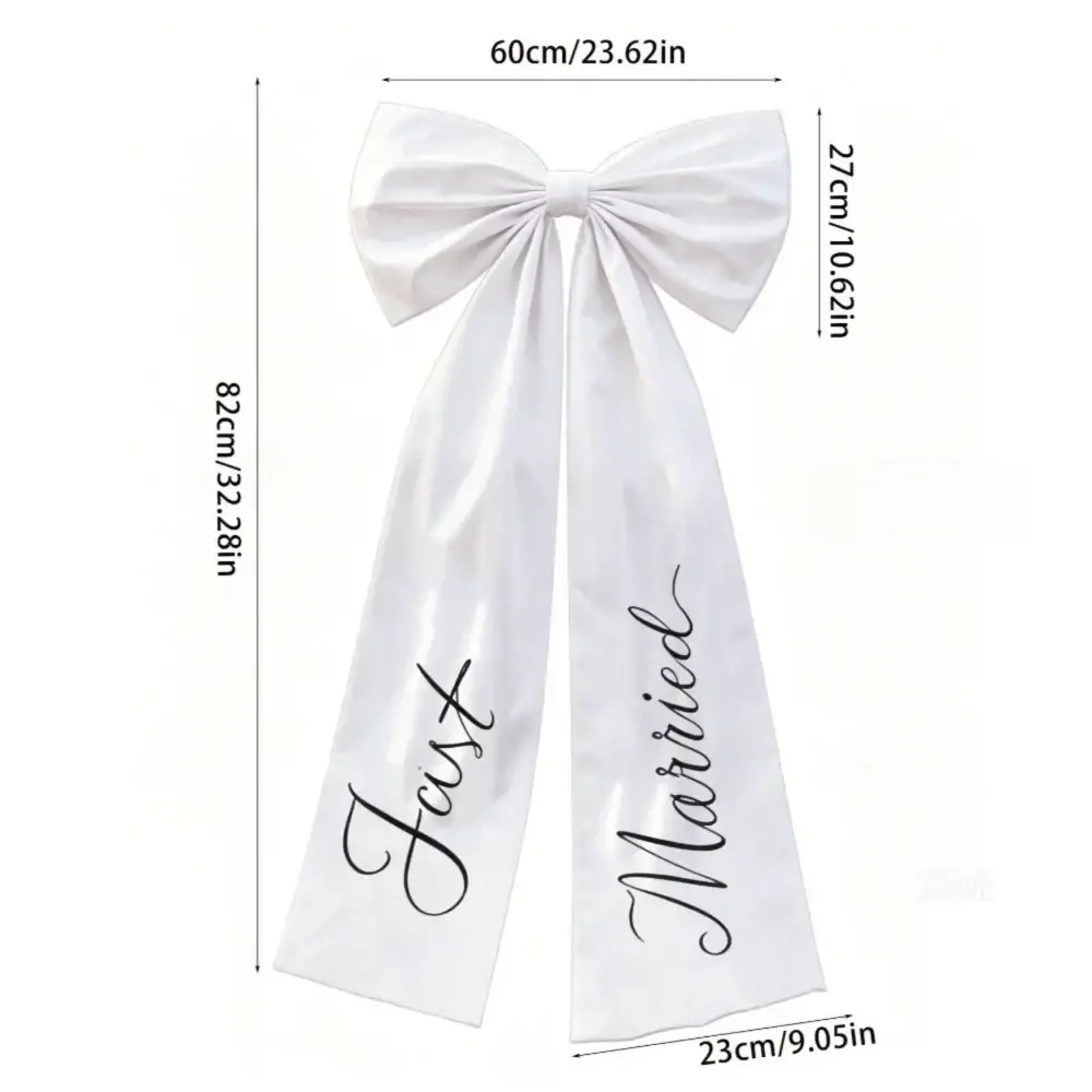 White satin large wedding car bow with elegant black cursive just married script for wedding day decor