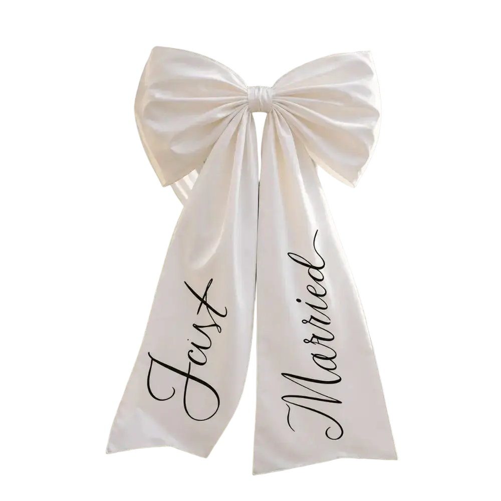 A white satin wedding car bow with a large bow and just married in elegant black cursive script
