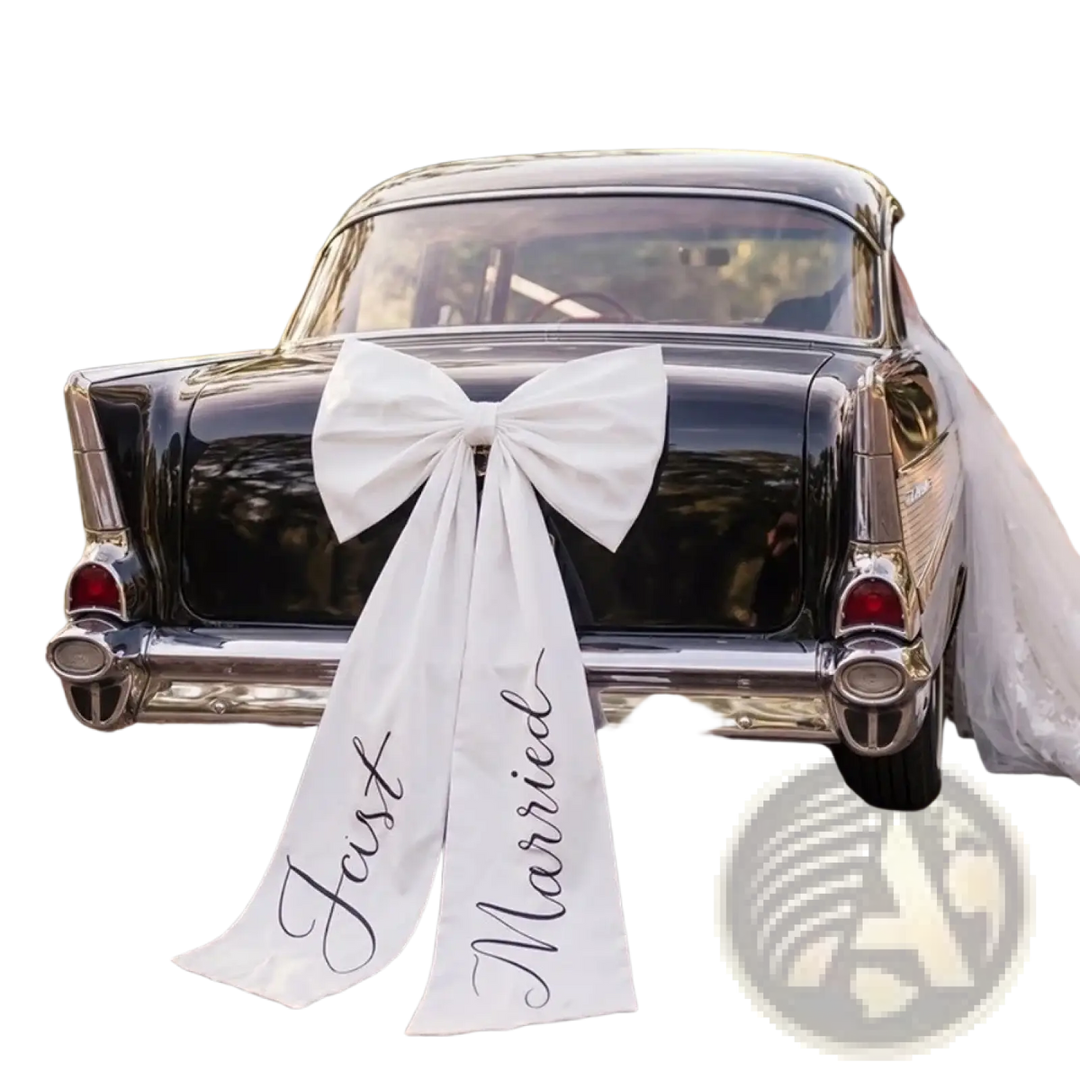 Large white satin wedding car bow with just married scripted in black cursive on the rear of a classic black car