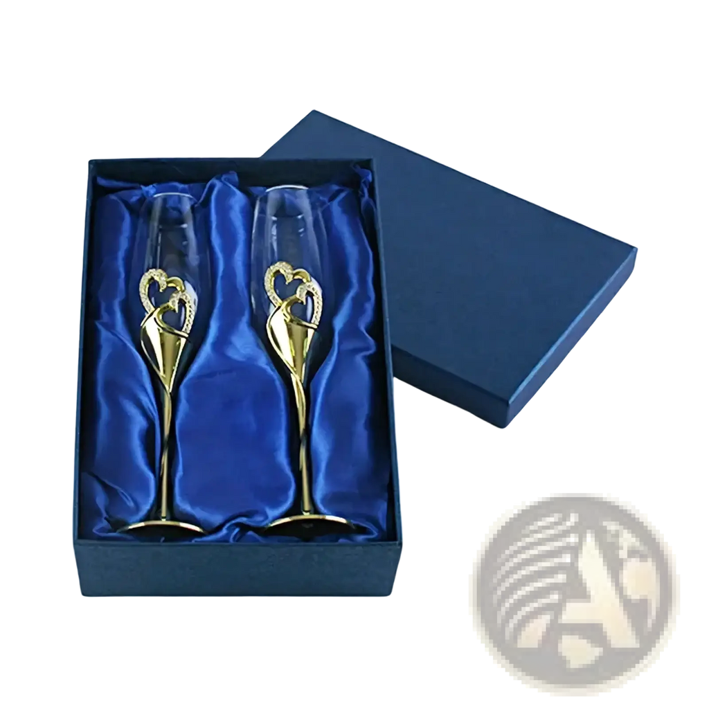 A pair of gold-finished wedding champagne flutes with intertwined heart designs in a blue satin gift box
