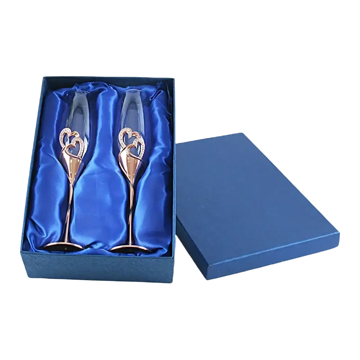 A pair of rose gold heart-themed wedding champagne flutes nestled in a blue satin-lined gift box