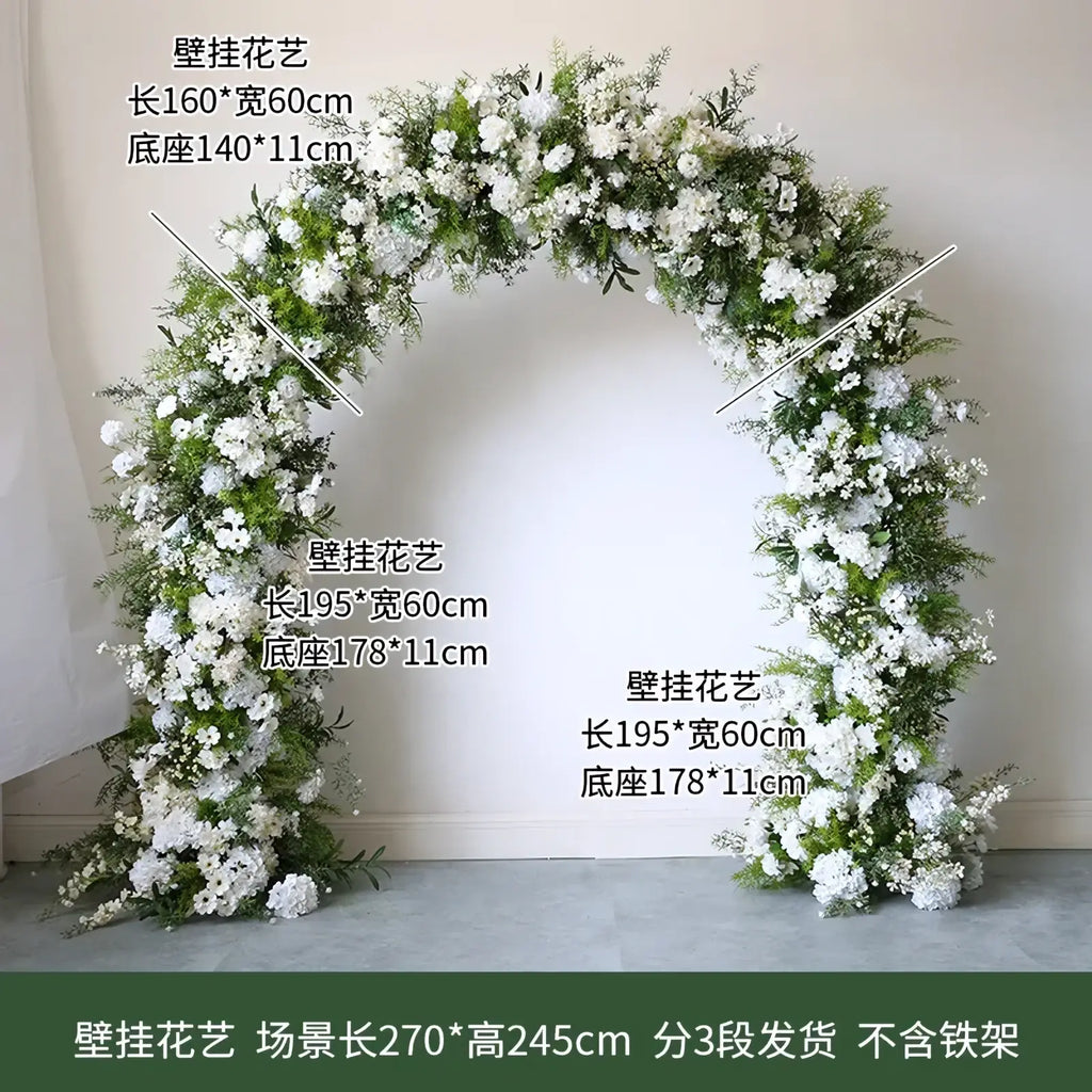 Wedding floral arch with stand featuring lush arched decoration of dense white artificial roses and green foliage