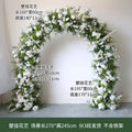 Wedding floral arch with stand featuring lush arched decoration of dense white artificial roses and green foliage