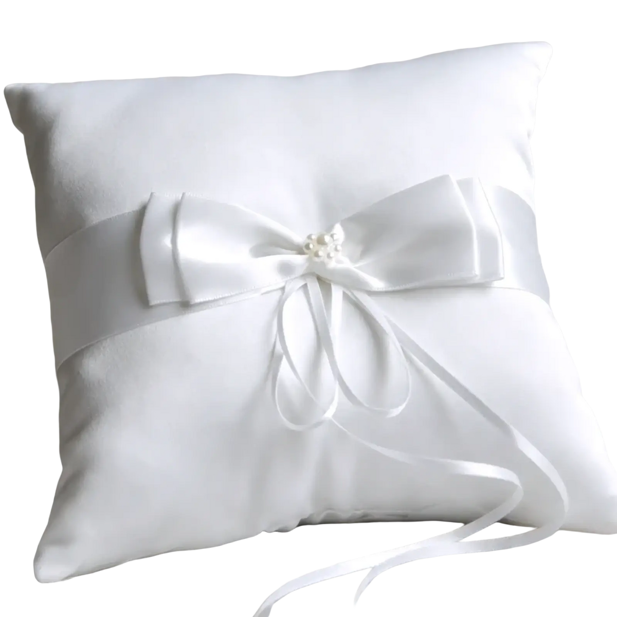 White satin ribbon bow adorning a plush white satin ring pillow from a wedding flower basket and ring pillow set
