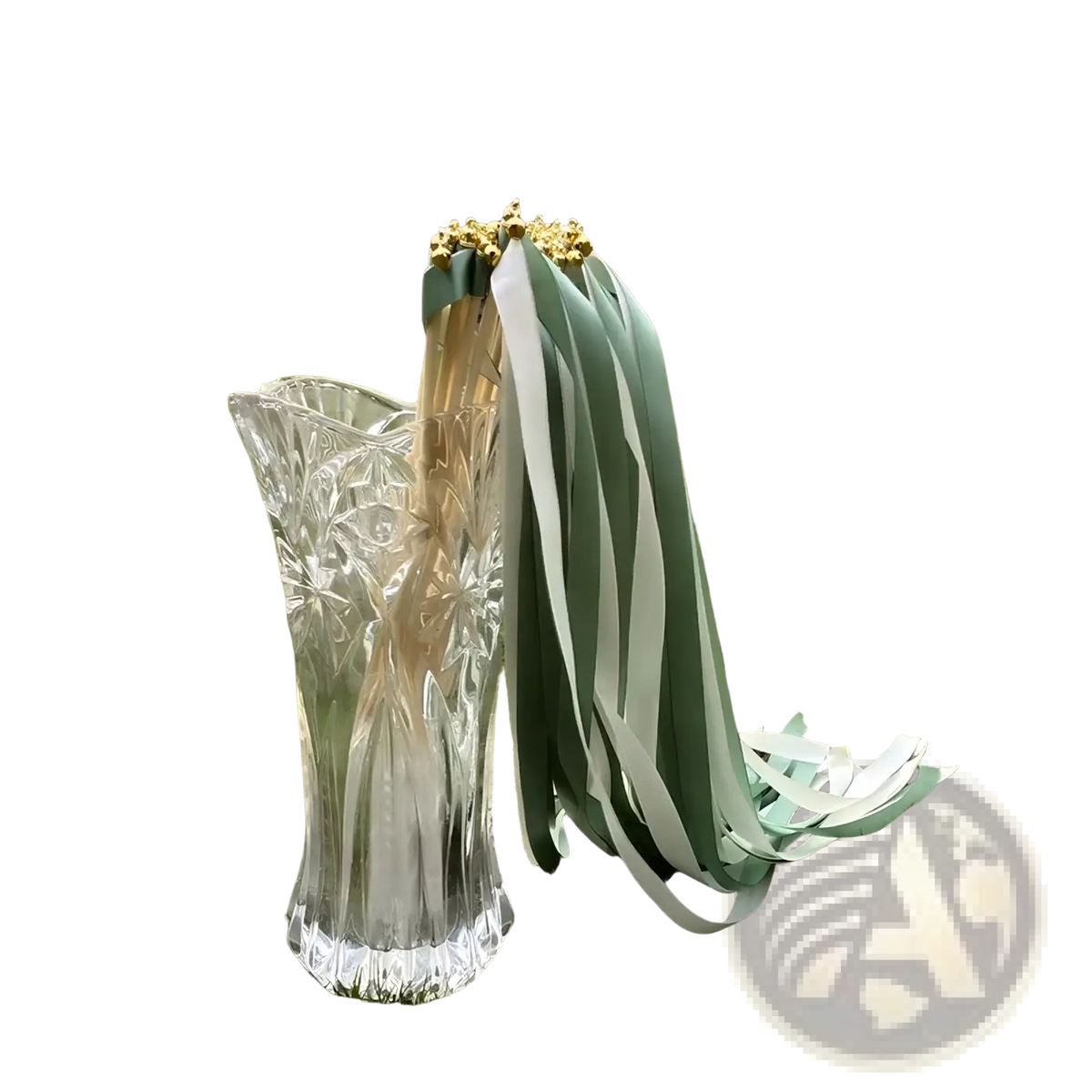 A clear intricately cut glass vase holding decorative wedding ribbon wands with sage green and white stripes 50 pack