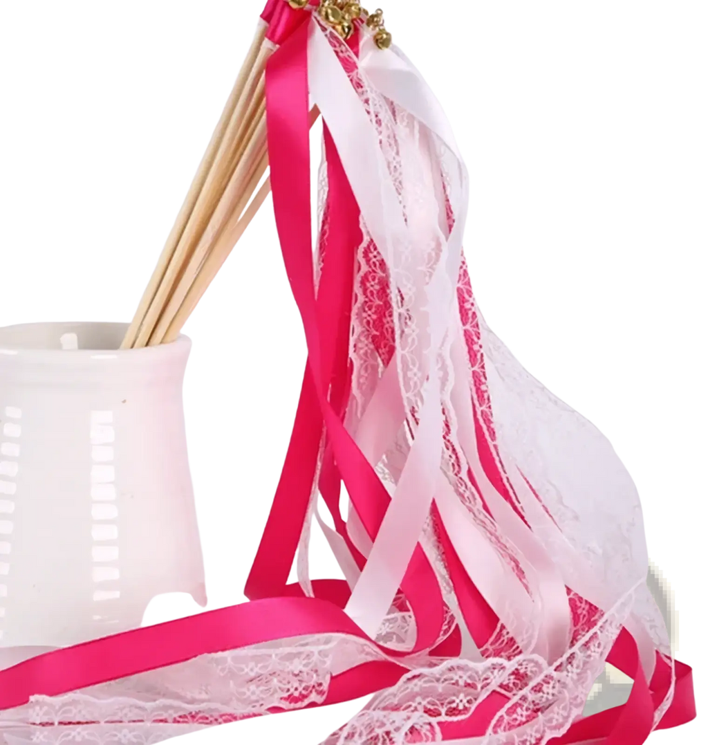 Wedding ribbon wand with vibrant pink and white satin ribbons intertwined with delicate lace and golden embellishment