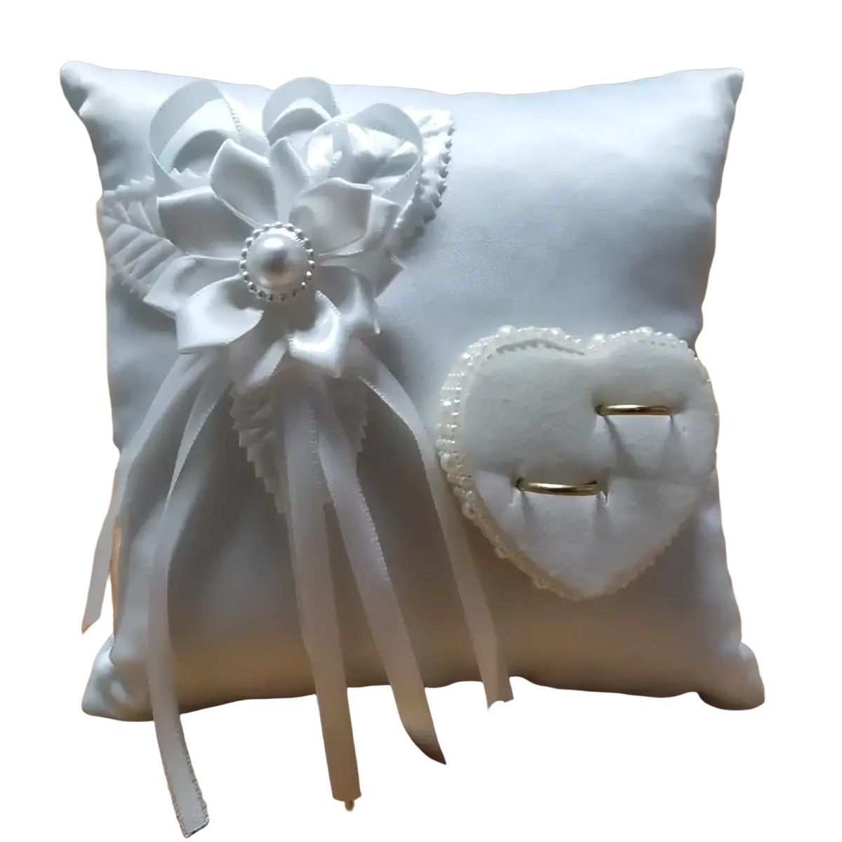 White satin heart wedding ring pillow with large floral bow and velvet heart-shaped ring holder for ceremony