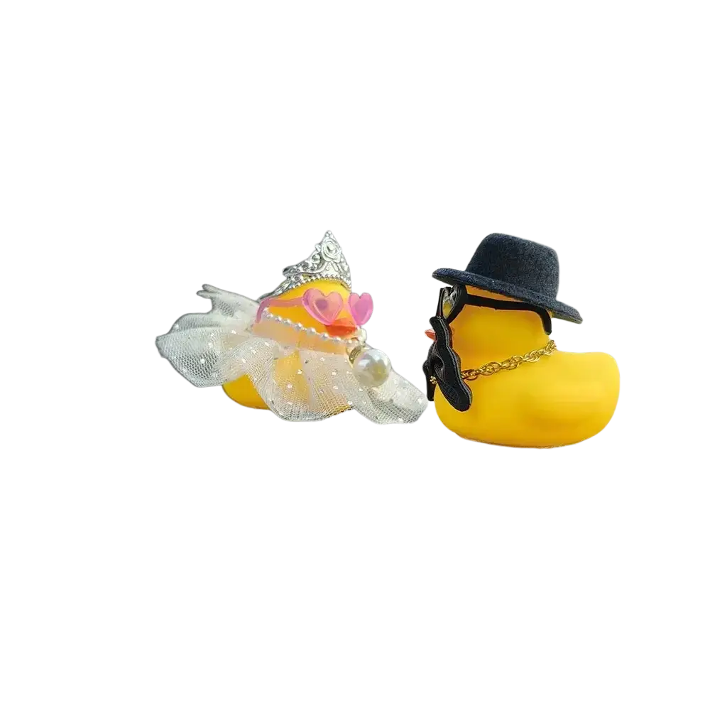 Two yellow rubber duck figurines dressed as wedding couple car dashboard ornaments with princess and gangster styles