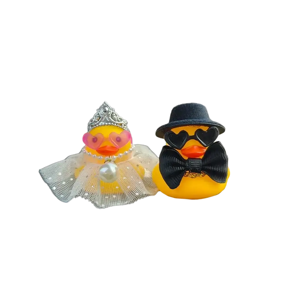 A charming yellow rubber duck wedding couple ornament for car dashboard featuring tiara and fedora accessories