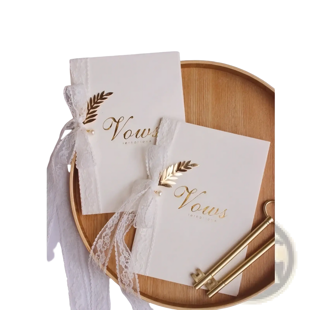 Elegant ivory wedding vow book with gold leaf script detailing and white lace ribbon from vow books set with keys