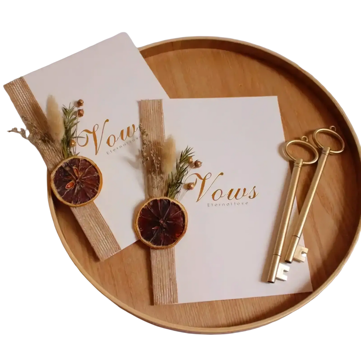 Wedding vow books set in white with gold keys ribbons adorned with dried orange slices rustic twine and greenery