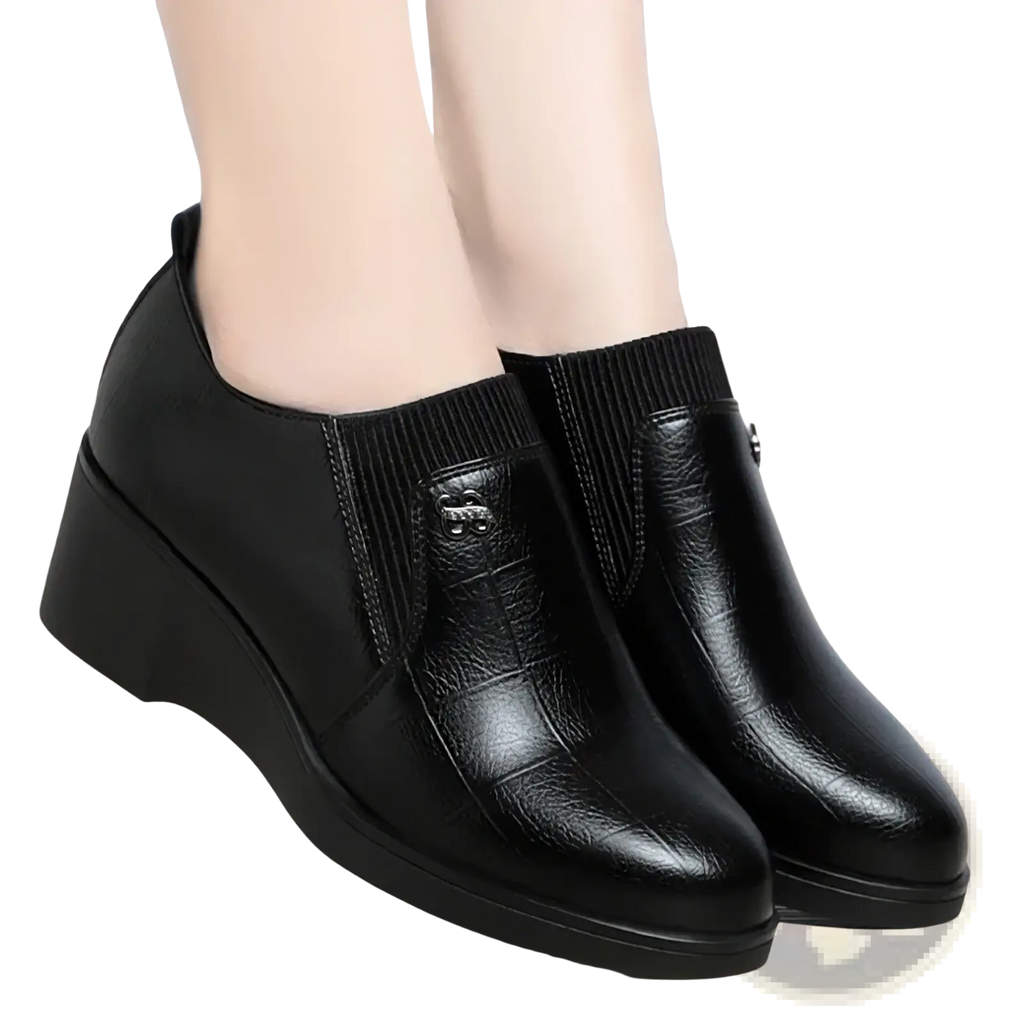 Black leather wedge ankle boots with ribbed elastic cuff and subtle embossed texture for comfortable slip on
