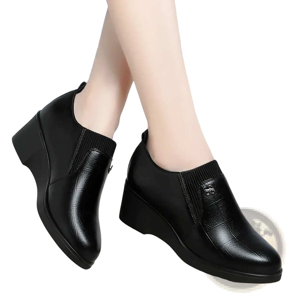 Black leather wedge ankle boots with ribbed knit cuff and subtle embossed logo for comfortable slip on wear