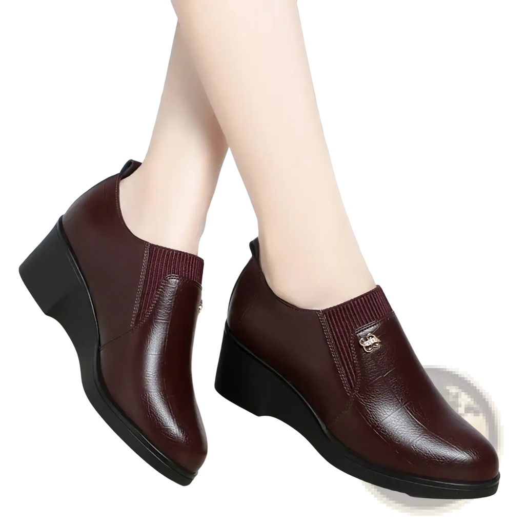 Burgundy leather wedge ankle boots with ribbed elastic side panel and small metallic buckle for comfortable slip on