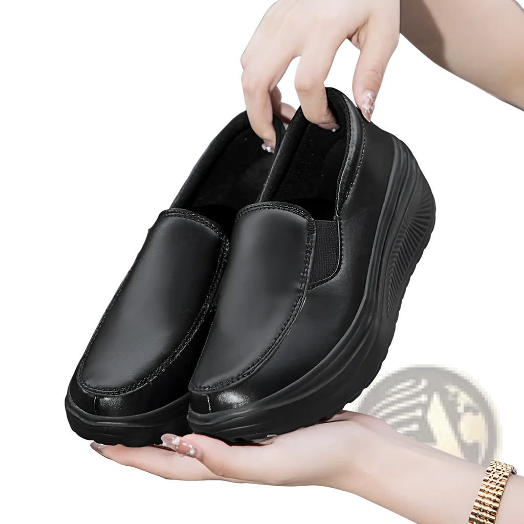 Black leather wedge heel platform slip-on shoes with thick textured sole for stylish comfortable wear