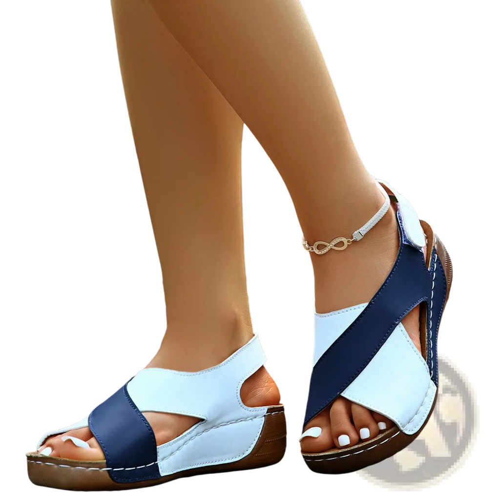Navy and white cross-strap wedge sandals with brown soles featuring a colorblock platform design for stylish comfort