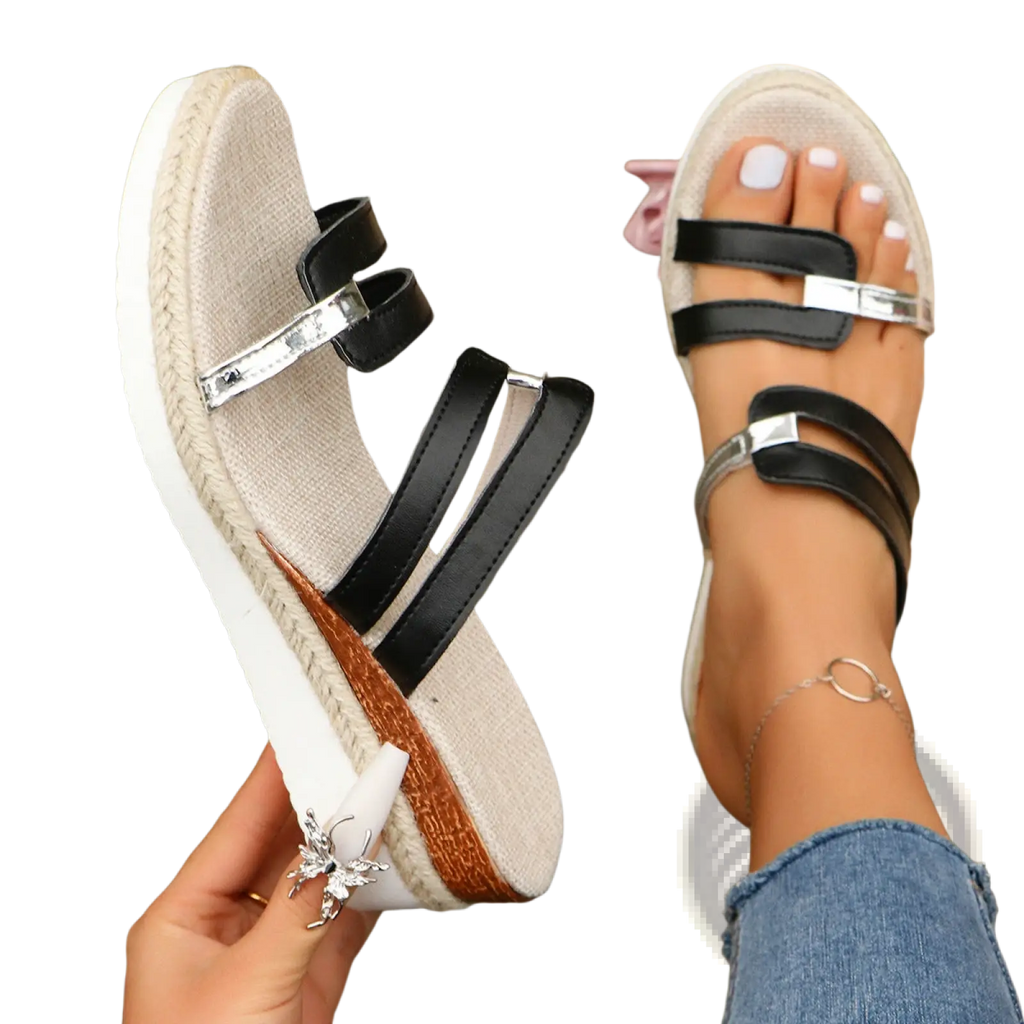 Black and silver wedge sandals with woven espadrille heel and metal accents shown from the back side