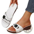 White wedge sandals for women featuring black buckle accents and brown platform soles ideal for summer casual wear