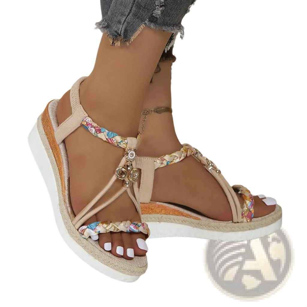 Beige wedge sandals for women with woven espadrille flats featuring colorful braided straps and metallic charms
