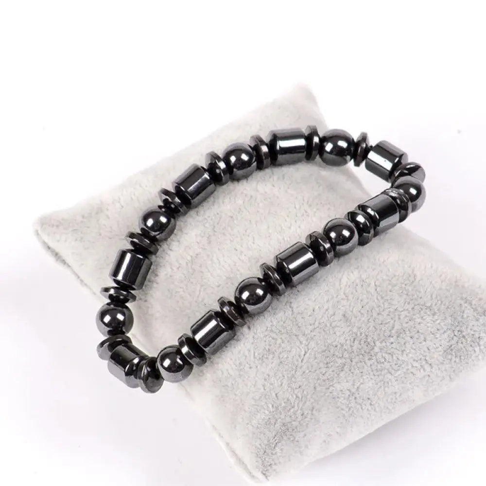 Black magnetic hematite therapy bracelet with alternating round and rectangular beads featuring a pentagram stone design