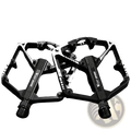 Black west biking aluminum alloy mtb pedals with textured grip surfaces and reinforced frame design shown from back side