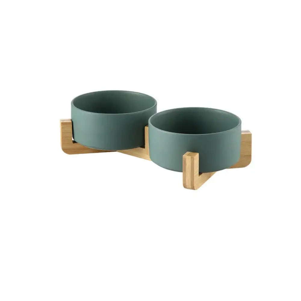 Set of two matte teal ceramic bowls mounted on a light wood stand from minimalist ceramic bowl set with wooden stands