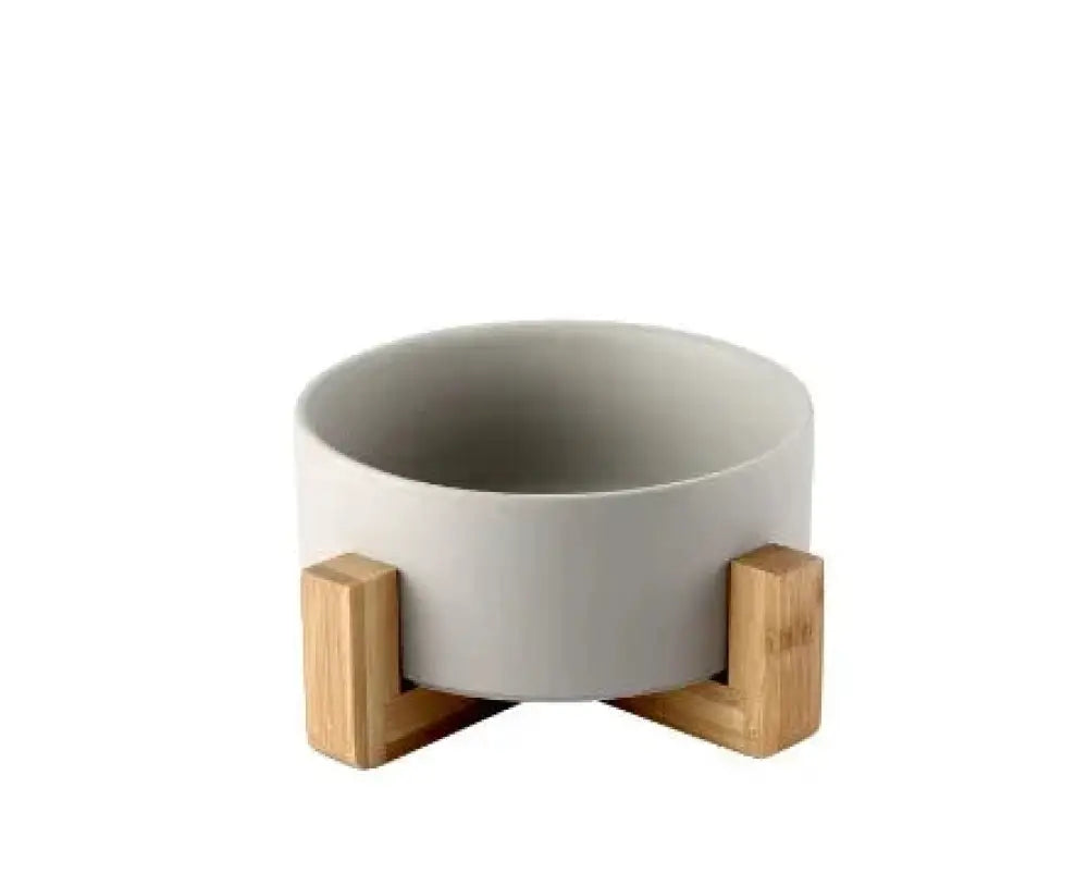Minimalist matte gray ceramic planter bowl with light wood stands for modern home decor and plant display