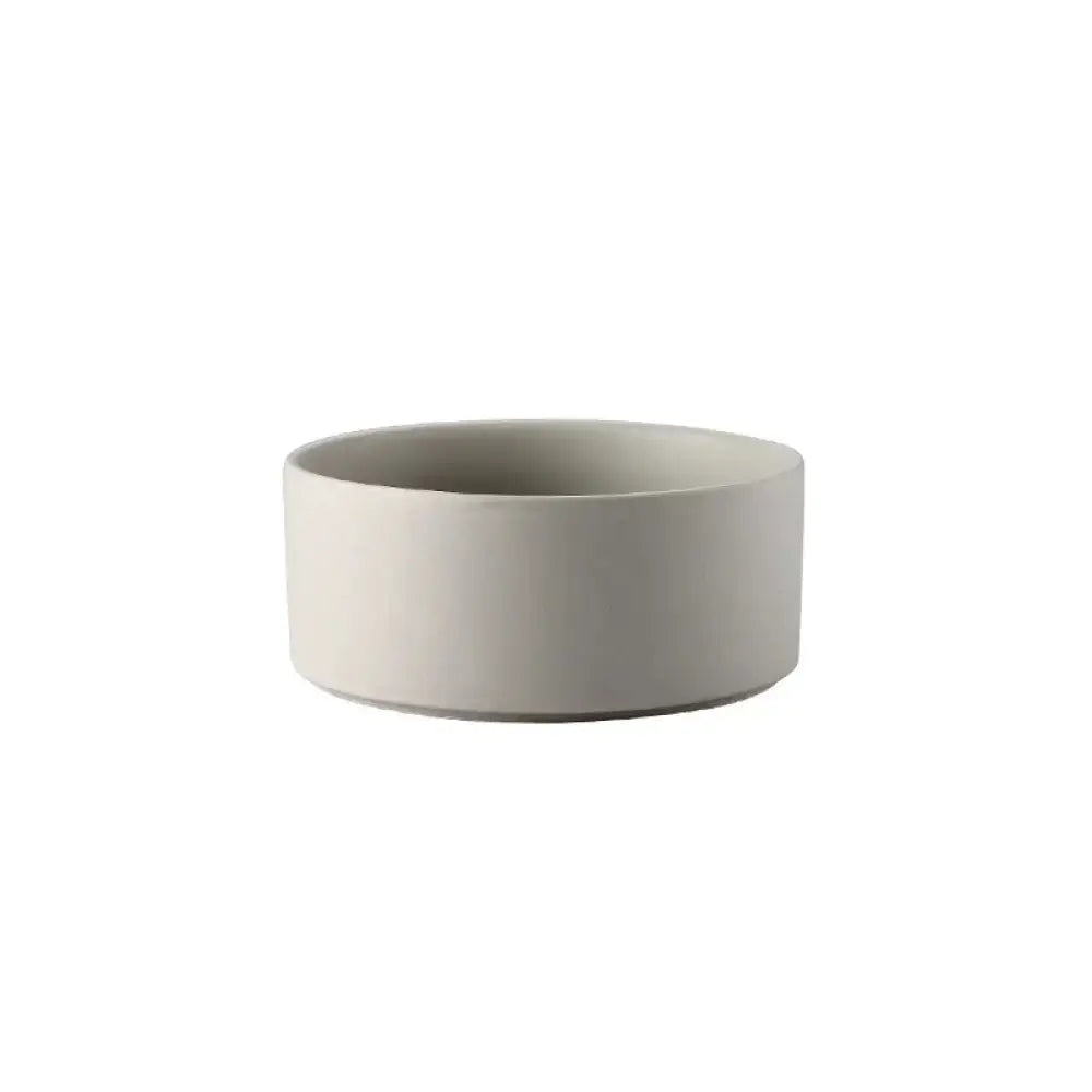 Minimalist off-white ceramic bowl with smooth matte finish and clean modern lines from ceramic bowl set with wooden stands