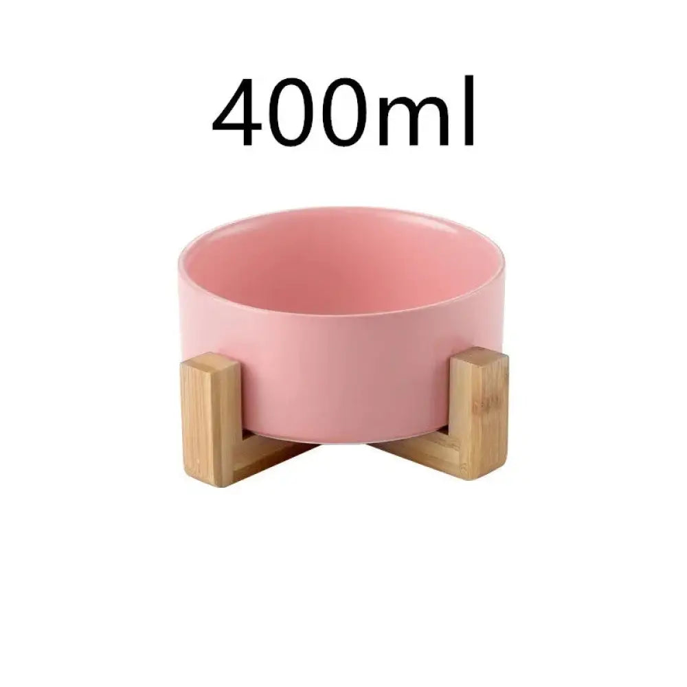 Pink ceramic pet bowl with 400ml capacity supported by light wood stands minimalist matte ceramic bowl set