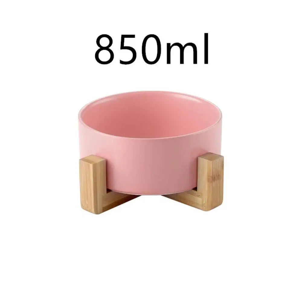 Pink minimalist matte ceramic pet bowl with 850ml capacity supported by light wooden stands