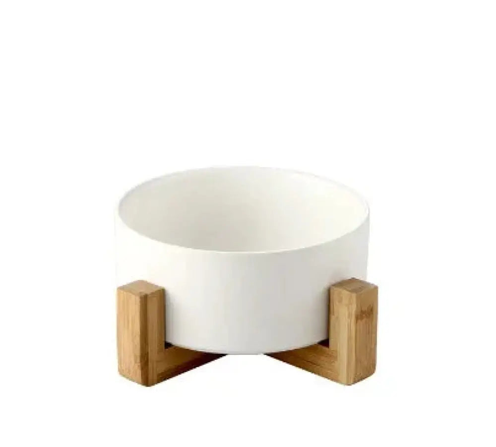 White matte ceramic bowl with minimalist design supported by light bamboo wooden stands in a set