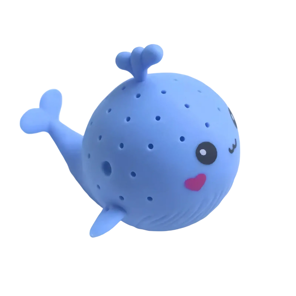 A light blue silicone whale-shaped bath sponge water toy for kids with cute face fins tail and tiny perforations