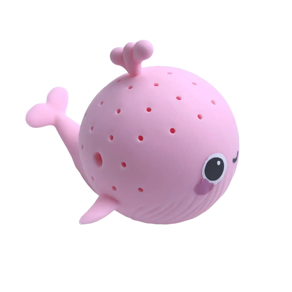 Pink silicone whale-shaped tea infuser with dotted texture and cute facial features for kids bath toys