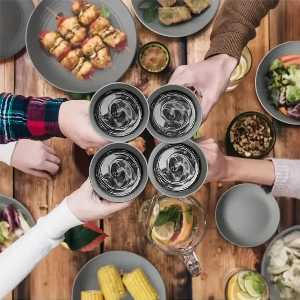 Four gray ceramic wheat straw mugs with swirling liquid reflections held together in a toast from a 16-piece dinnerware set