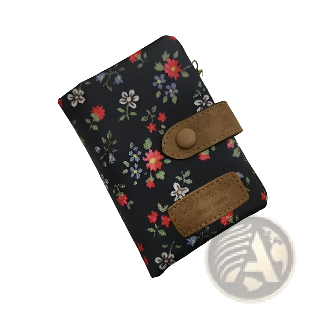 Whimsical patterned canvas tri fold multi card wallet in black floral with brown leather accents and brass charm