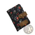 Whimsical patterned canvas tri fold multi card wallet in black floral with brown leather accents and brass charm