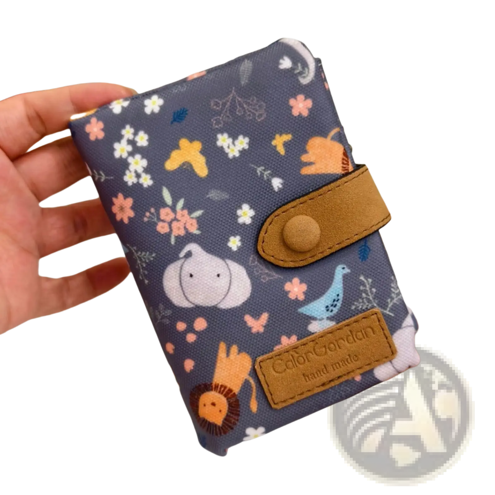 A navy blue canvas tri fold multi card wallet with playful cartoon animals flowers tan leather straps and branded patch
