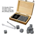 Whiskey stones gift set with gray cube-shaped stones in a light wood box with steel tongs and black velvet bag