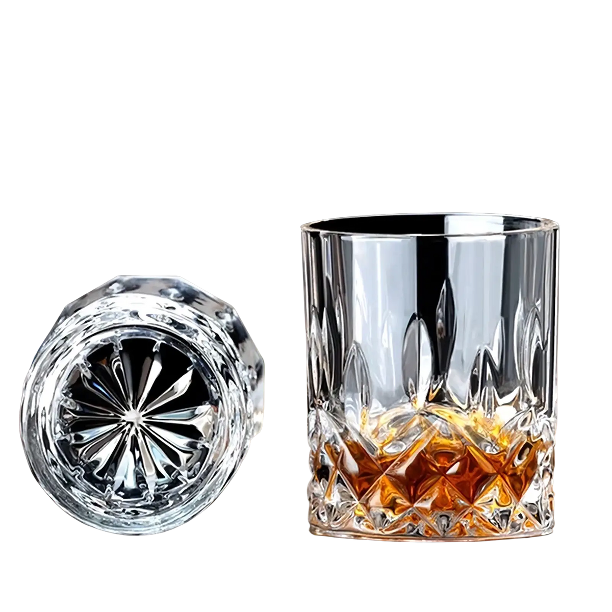 A clear faceted crystal whiskey glass with double-walled design and intricate cut patterns in a whiskey stones gift set