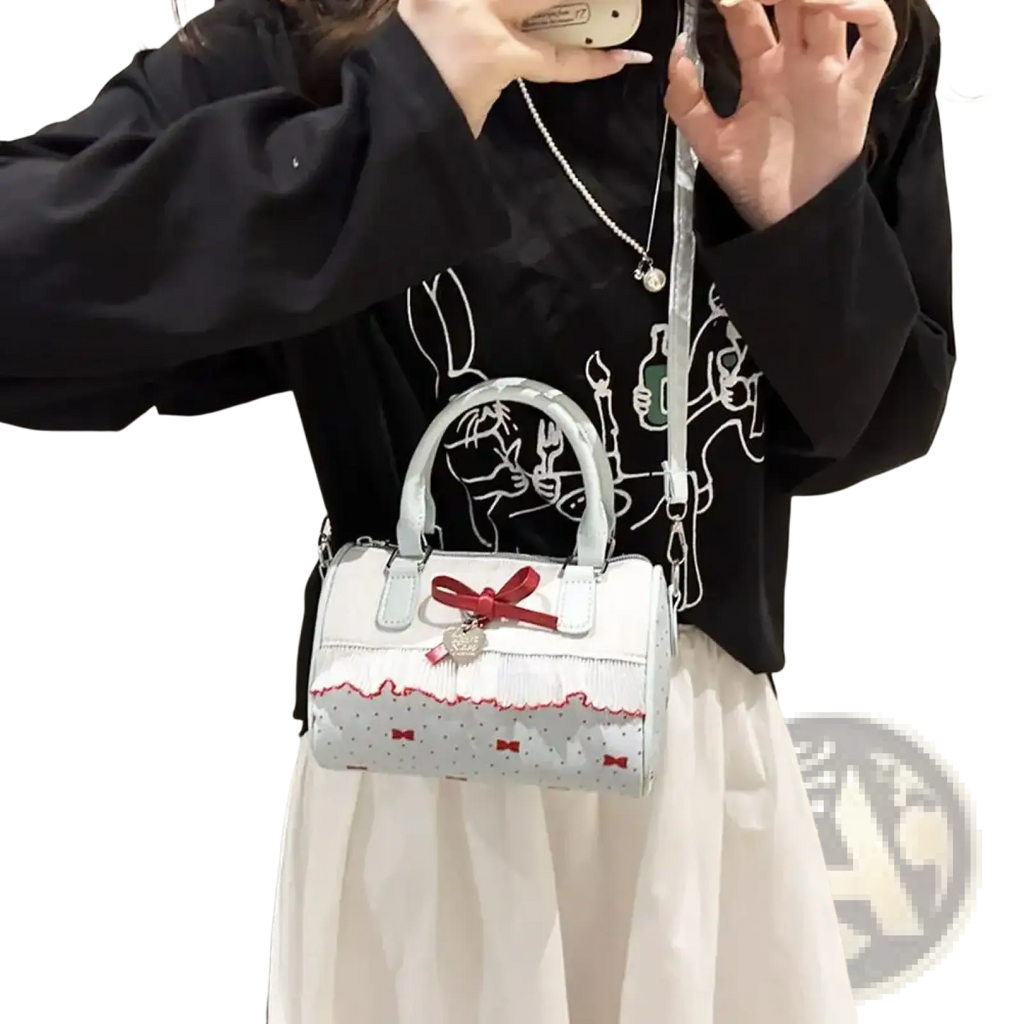 White bow crossbody pu leather handbag with white lace trim silver handles and a red bow accent
