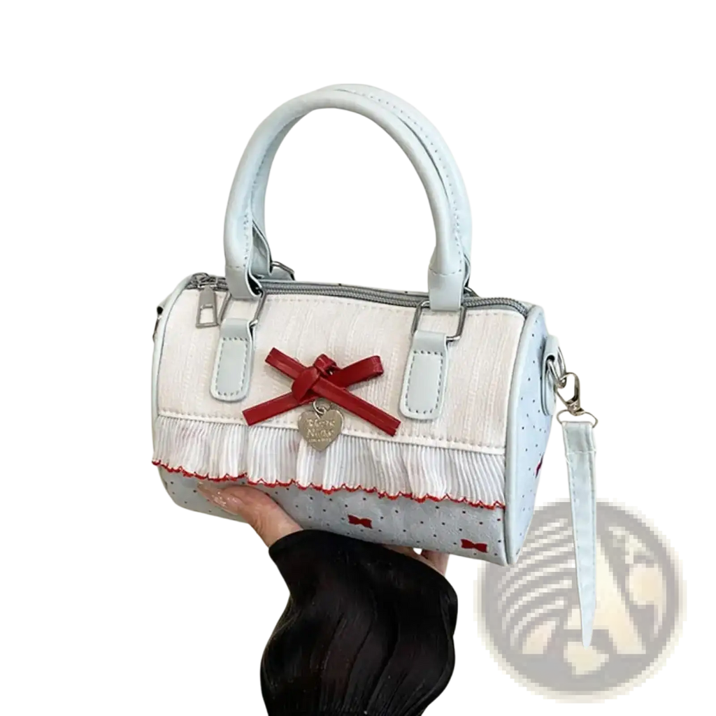 White bow crossbody pu leather handbag in light blue and white polka dot with red bow, fringed trim, and heart charm