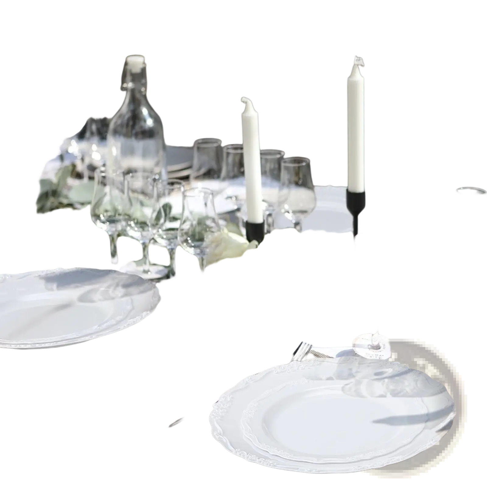 Elegant white ceramic plates with delicate scalloped edge arranged for outdoor dining in a 100 piece lace design set