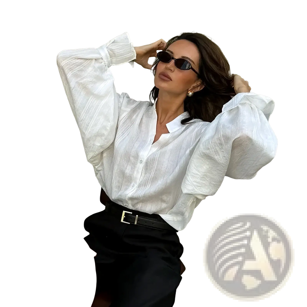 White cotton oversize blouse with voluminous puff sleeves and subtle textured fabric for elegant wear