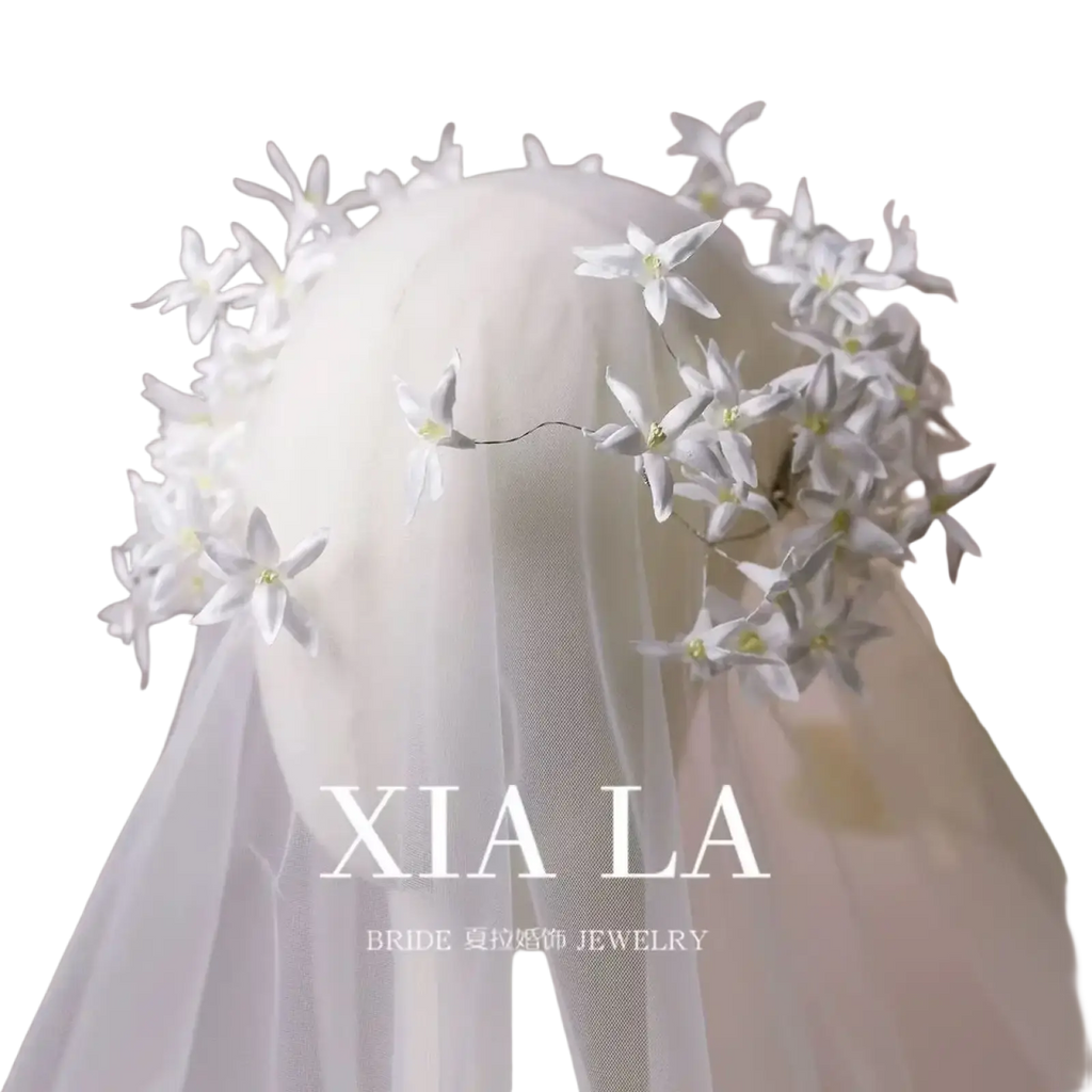 Elegant white floral wedding hair crown featuring delicate handcrafted blossoms and fine wire detailing for brides