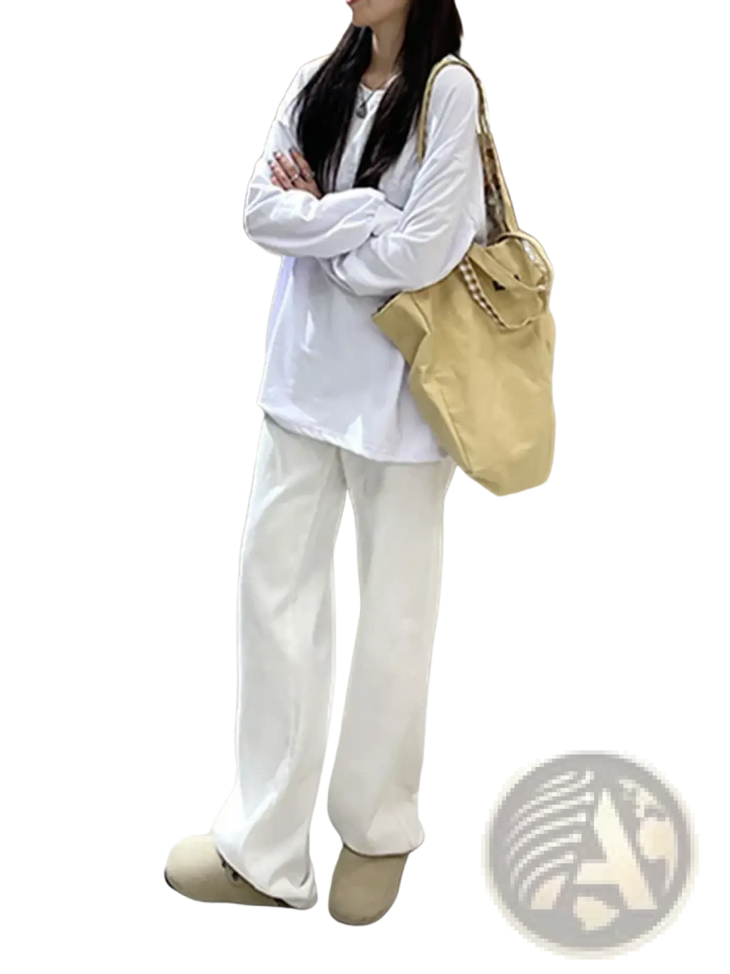 Beige canvas tote bag with a chain strap displayed alongside white high waist wide leg jeans