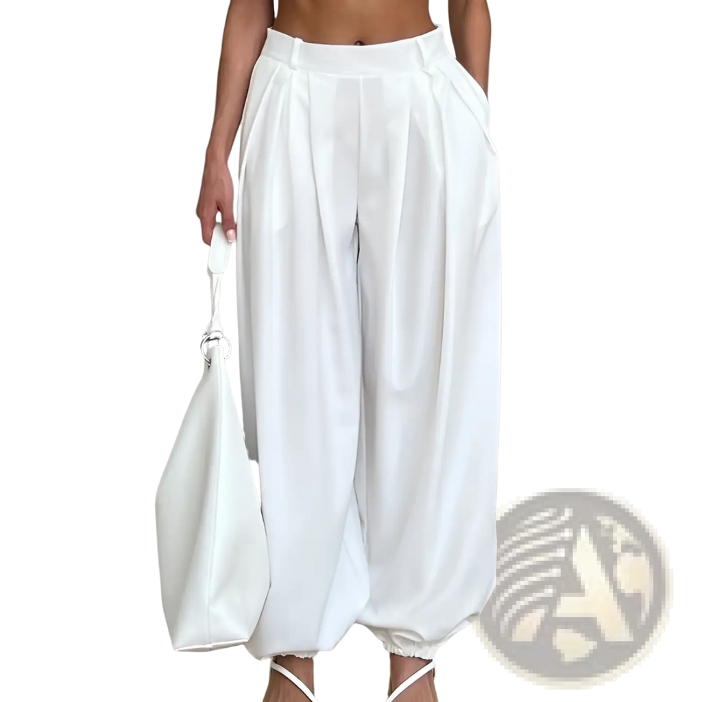 White high waisted balloon jogger pants with pleated design and elastic cuffs in a relaxed flowing silhouette